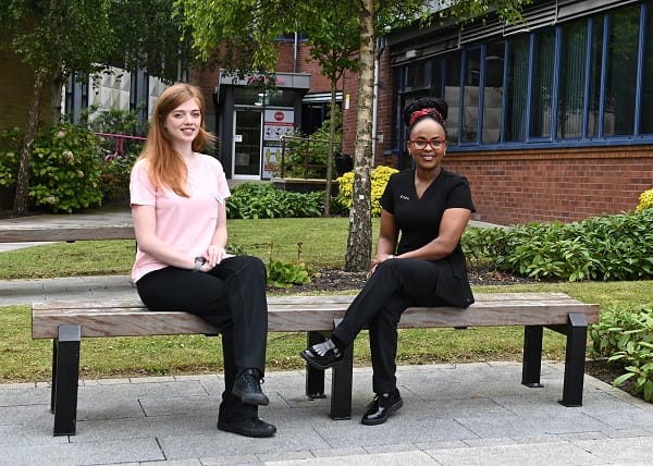 Beauty Students pictured setting on bench outside SERC.